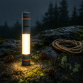 Stormbeam SB-1 LED tube light glowing on wet rock in night rain - Stronghold Outfitters